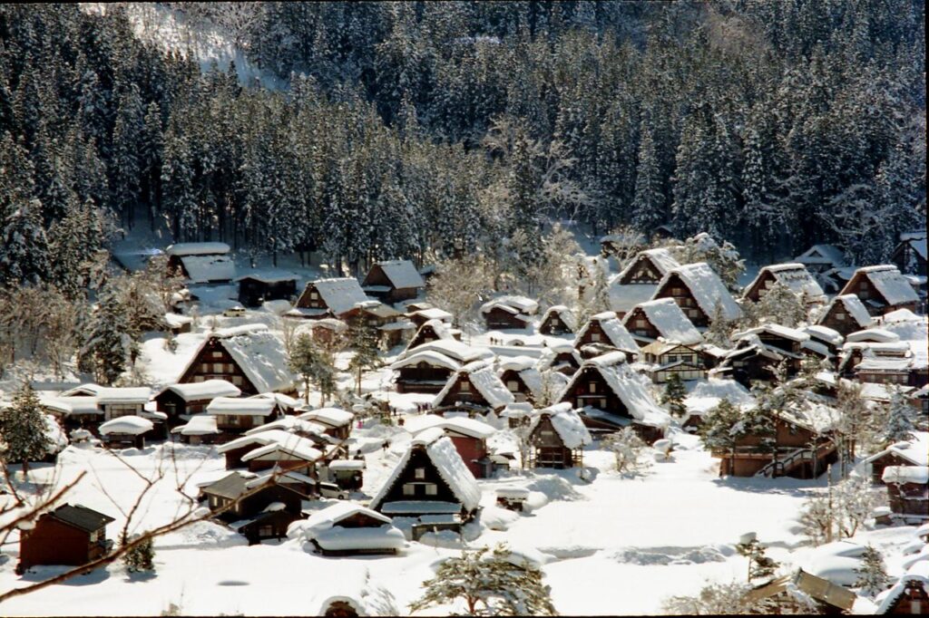 Trip Search Result A scenic view of Shirakawa-go village in Japan, blanketed in winter snow.