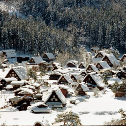 A scenic view of Shirakawa-go village in Japan, blanketed in winter snow.