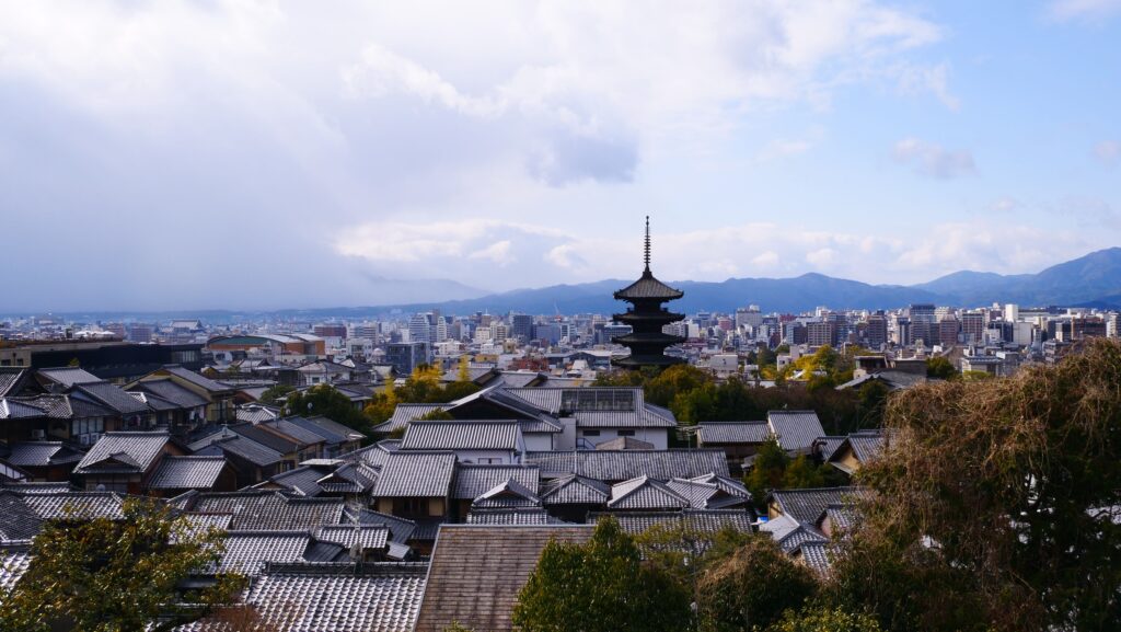 Trip Search Result A breathtaking view of Kyoto city with traditional pagoda and modern skyline.