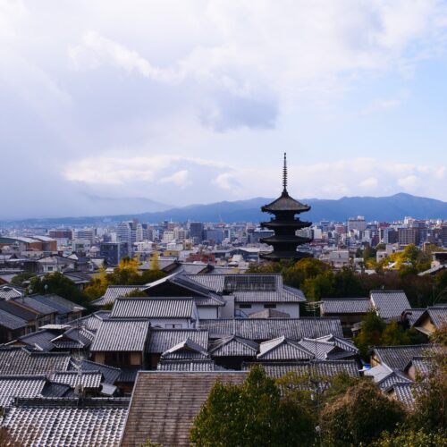 A breathtaking view of Kyoto city with traditional pagoda and modern skyline.