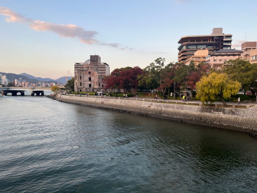 Trip Search Result Scenic view of Hiroshima Peace Memorial Park with autumn foliage along the river.
