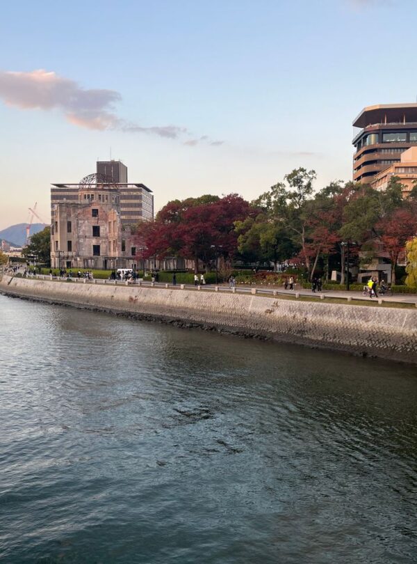 Scenic view of Hiroshima Peace Memorial Park with autumn foliage along the river.
