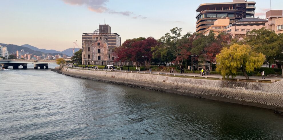 Scenic view of Hiroshima Peace Memorial Park with autumn foliage along the river.