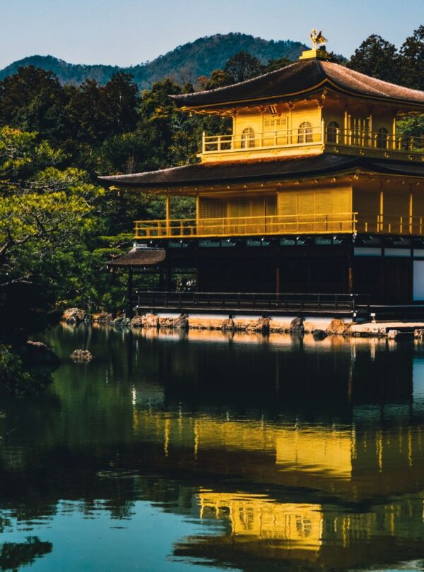 Stunning view of the Golden Pavilion reflected in a serene lake at Kinkaku-ji Temple, Kyoto.