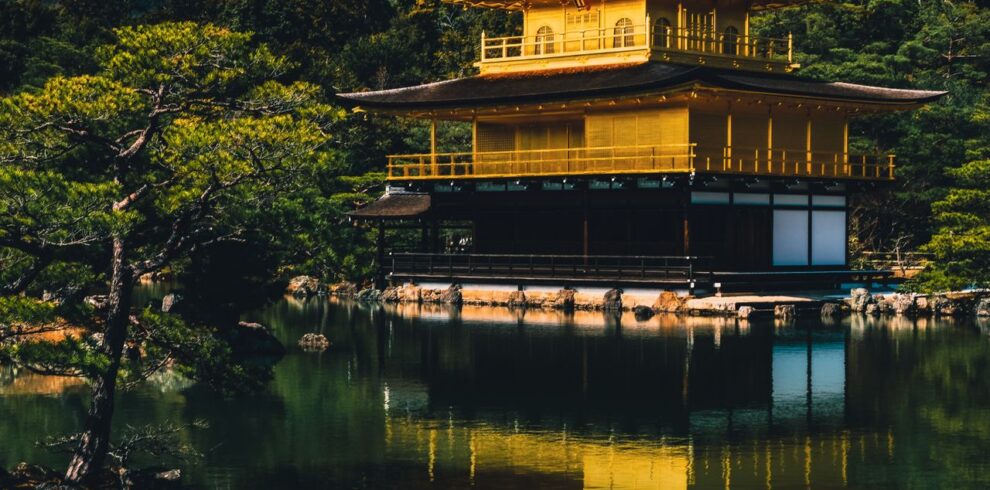 Stunning view of the Golden Pavilion reflected in a serene lake at Kinkaku-ji Temple, Kyoto.