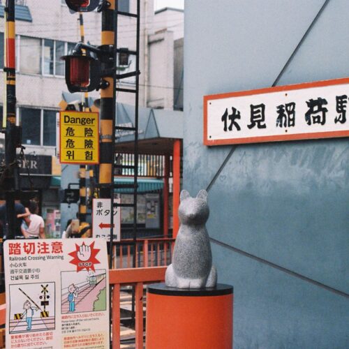 Explore the vibrant daily life near Fushimi Inari Station in Kyoto, Japan, showcasing unique Japanese architecture.