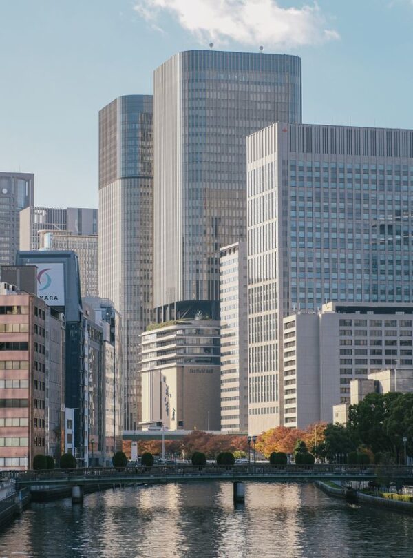 A modern urban landscape featuring tall skyscrapers and a quiet river, offering a peaceful city view.