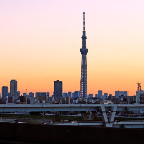 A stunning view of Tokyo Skytree at sunset, towering over the urban skyline.