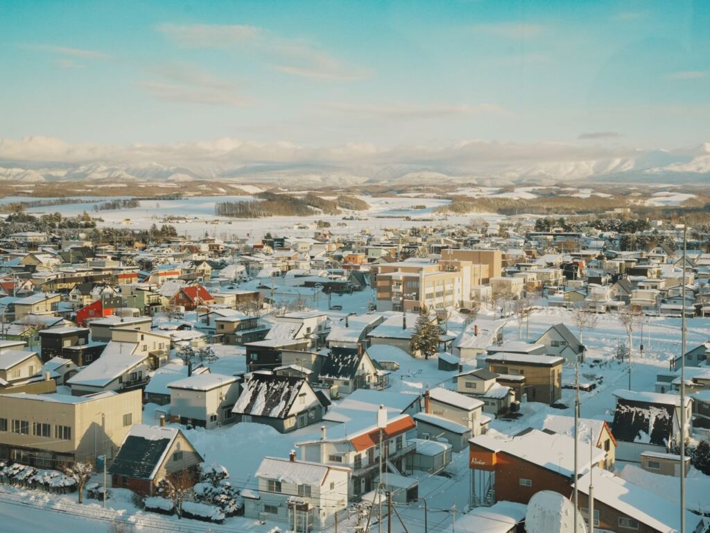 Scenic aerial view of a snow-covered town in Hokkaido, Japan during winter.