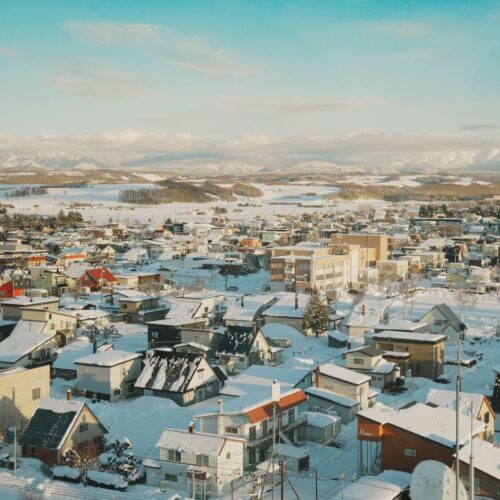 Scenic aerial view of a snow-covered town in Hokkaido, Japan during winter.