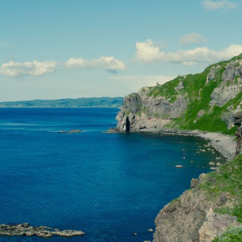 Stunning view of rocky cliffs and blue ocean in Hokkaido, Japan.