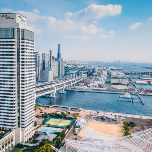 Elevated view of Kobe cityscape featuring modern architecture along the waterfront.