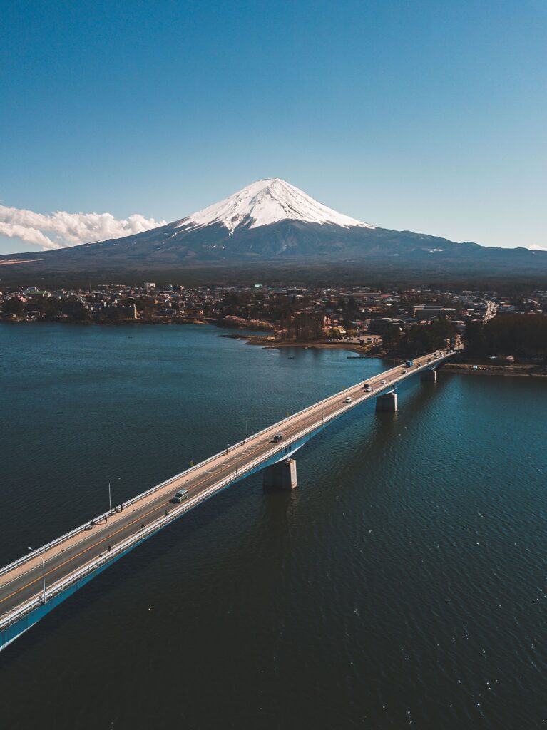 Stunning aerial view of Kawaguchiko Bridge with majestic Mount Fuji in the background.