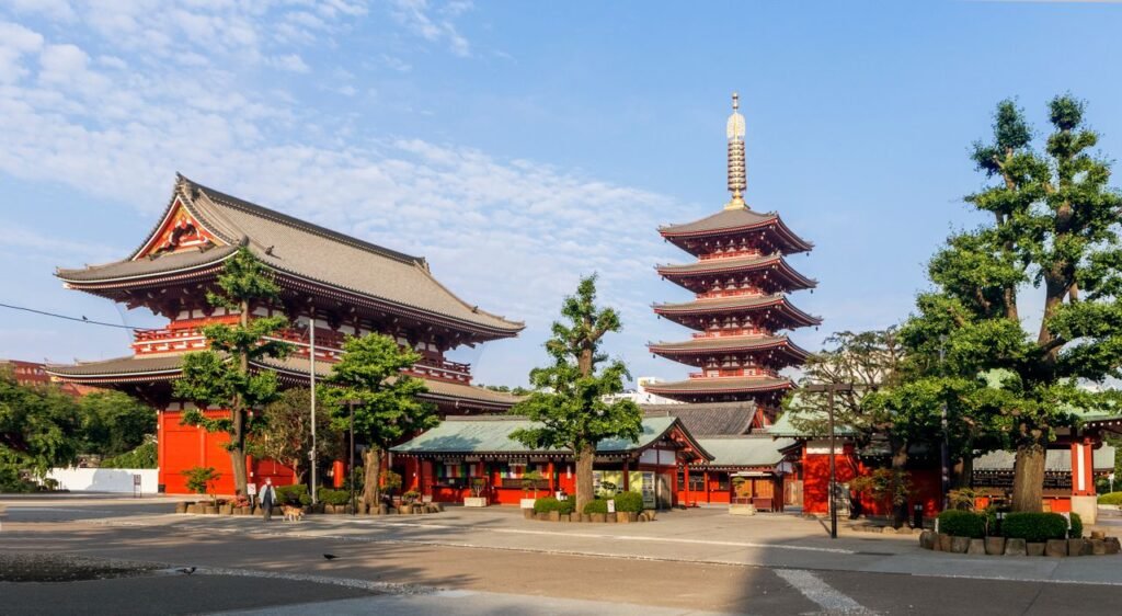Sunny view of Senso-ji Temple and Five-Storied Pagoda in Tokyo, showcasing traditional Japanese architecture.